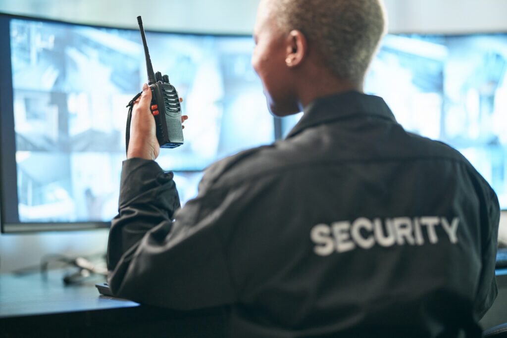 Back, security and radio surveillance with a woman officer in a control to monitor criminal activit