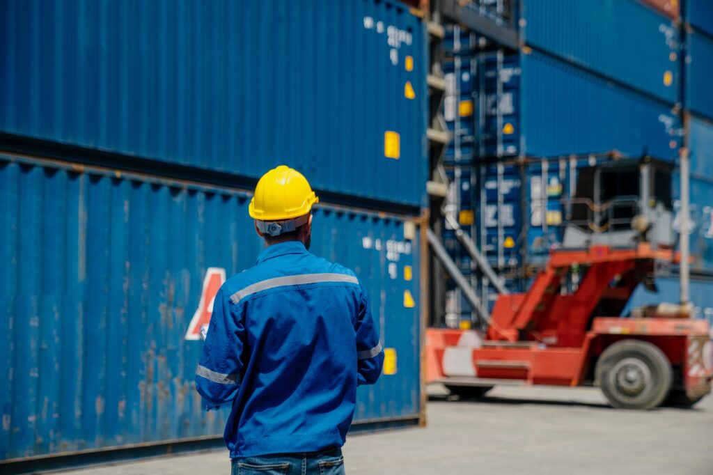 Working in cargo container warehouse industry factory site in export, import, and transportation.